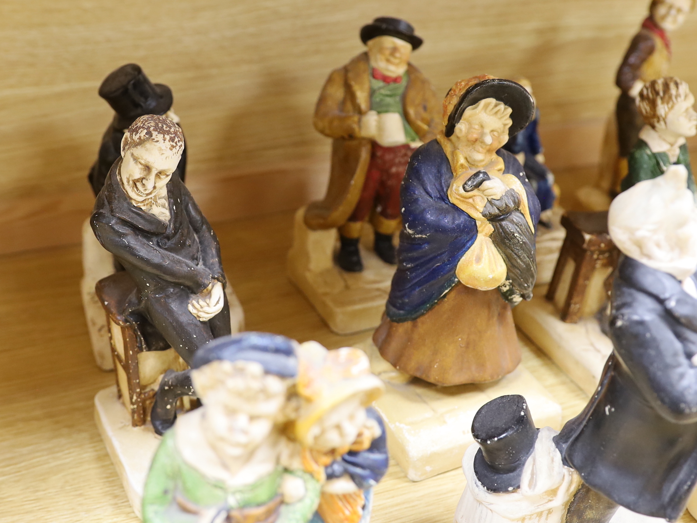 A collection of twelve Bretby cold painted pottery Dickens character figures, tallest Mr. Micawbee 25cm high